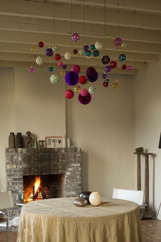 colorful ornaments hanging over the table will give a festive feel to the space and will make it brighter