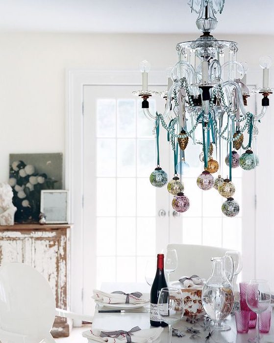 hang some pastel Christmas ornaments on your chandelier to make it cute and chic
