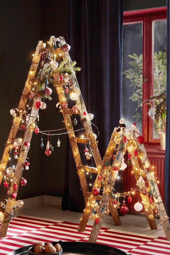 ladders covered with lights, with red, white and green ornaments and snowflakes can be alternative to usual Christmas trees