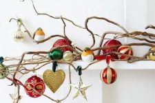 vine-like branches on the mantel with a whole assortment of beautiful Christmas ornaments will add a festive feel to the space