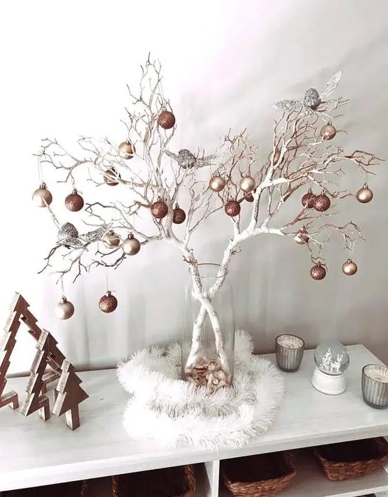 white branches decorated with copper, matte gold and silver ornaments are a nice Christmas ornament display and decoration