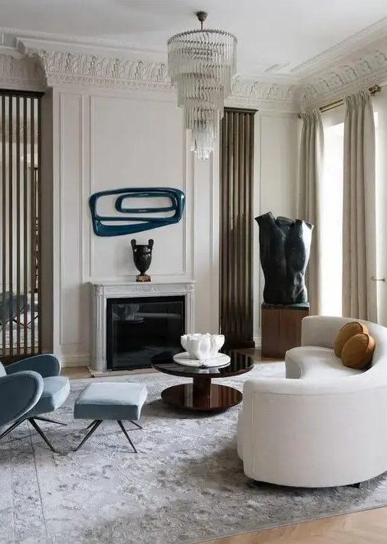 a refined living room with a curved white sofa and catchy decor and artworks that continue the unique style of the room