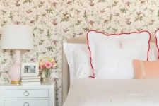 a cute bedroom with a floral wallpaper