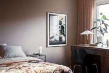 20 a stylish modern brown bedroom with a bed and printed bedding, a dark-stained desk and a black chair