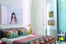 23 a colorful boho bedroom with bright boho bedding, turquoise curtains, fuchsia nightstands and a green bed plus a bright artwork