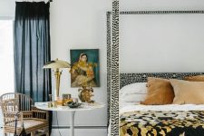 30 an eye-catchy bedroom with a printed bed and bedding, printed rugs, art, a rattan chair and some pillows