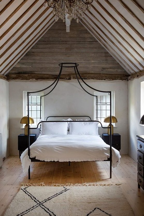 a quirky canopy bed in black on tall legs is a great idea for an eclectic room like this one