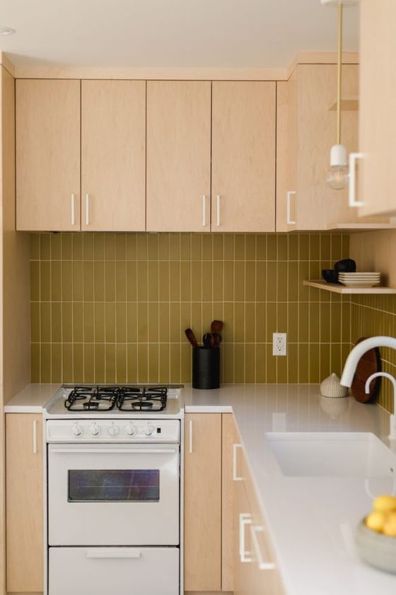 a light colored plywood kitchen with a mustard stacked tile backsplash and white fixtures for a fresh touch