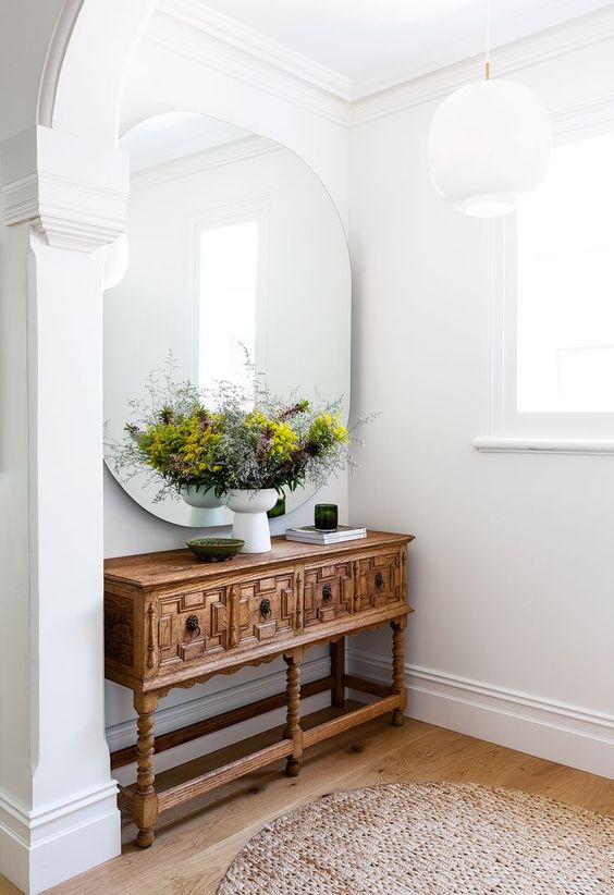 a chic and refined stained carved Victorian console table is a lovely addition to a modern home