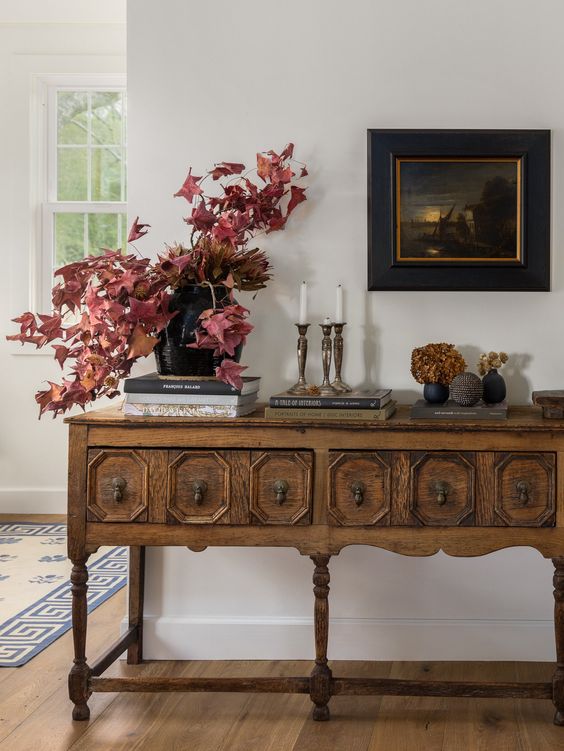 a beautiful vintage carved console table with black handles is a cool and catchy idea for any space