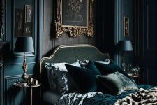 a Gothic bedroom with teal walls, a dark green bed with teal bedding, vintage art and teal table lamps