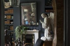 a Gothic living room with a tiled fireplace, molding, black furniure, unique artworks and greenery in pots