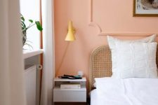 a Peach Fuzz accent wall paired with neutrals creates a soft and warm ambience where you’ll really want to be