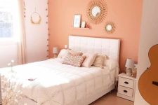 a Peach Fuzz bedroom with a white bed and bedding, a jute rug, nightstands with lamps and a woven lamp