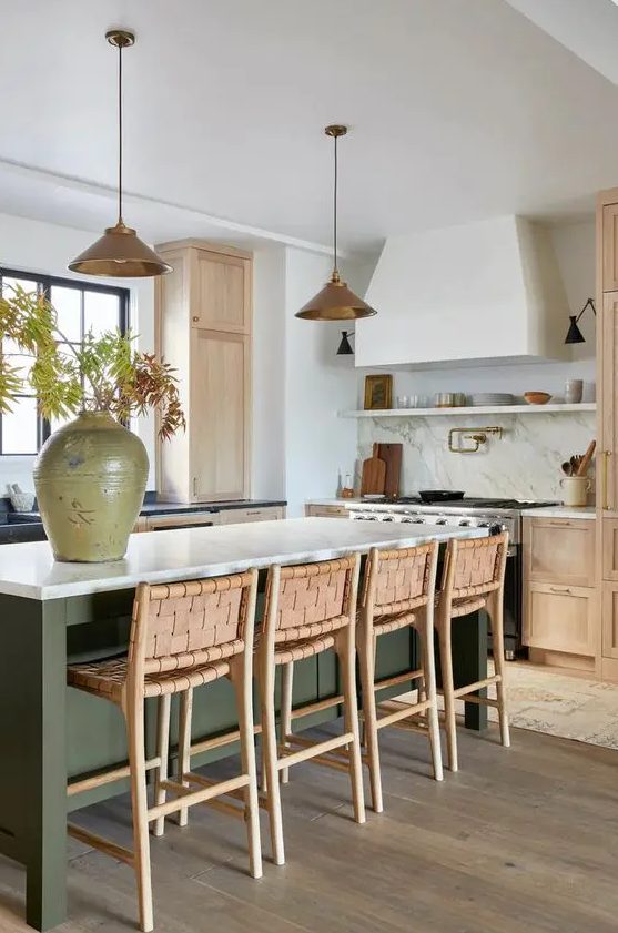 a beautiful modern kitchen with stained cabinets and a dark green kitchen island, white stone countertops and woven stools
