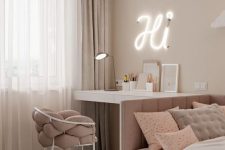 a beautiful white and dusty pink teen girl bedroom with various printed textiles, a neon light and a table lamp