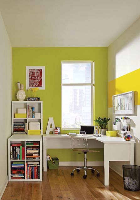 a bold home office with a chartruse accent wall, a white desk, a storage unit, a memo board some plants and decor