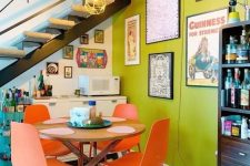 a bold nook with a chartreuse wall, a stained table and coral chairs, a gallery wall, a home bar and a storage unit