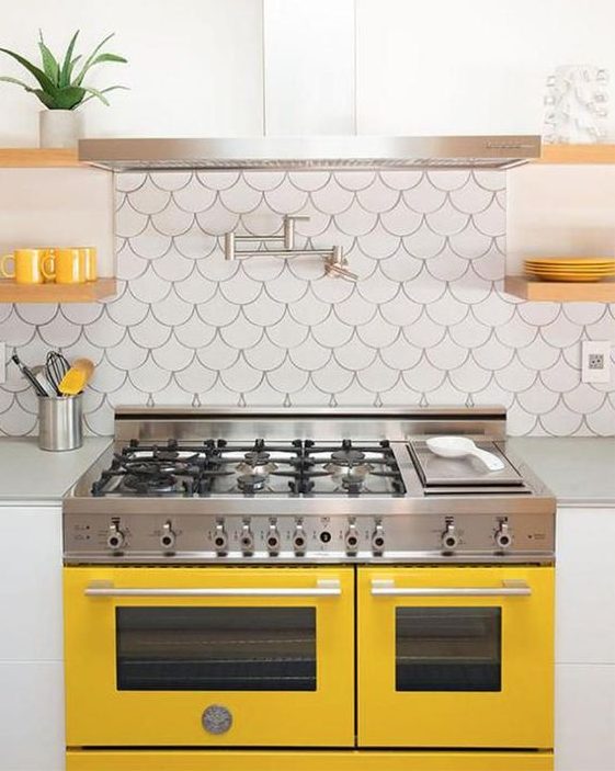 a bright and fun kitchen with touches of sunny yellow and fishscale tiles on the backsplash