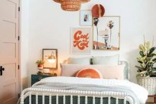 a bright and fun mid-century modern teen bedroom with a white bed and pastel bedding, woven stools, a woven pendant lamp and artwork