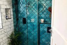 a catchy bathroom done with subway marble, penny and bold teal and turquoise fishscale tiles, with black fixtures