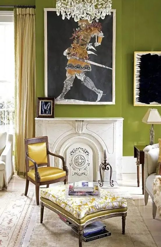a chartreuse living room with a fireplace, a refined sofa, chair and ottoman, some statement art and a crystal chandelier