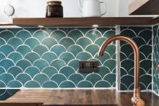 a contemporary kitchen with butcher block countertops, wooden shelves and teal fishscale tiles