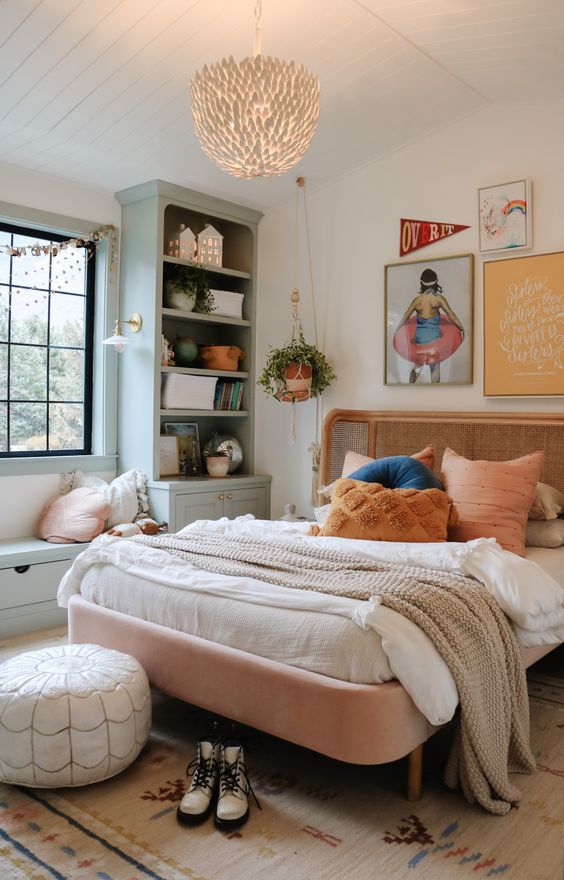 a cool modern girl's room with grey storage units and a bench, a pink bed wiht neutral bedding, a gallery wall and a pouf