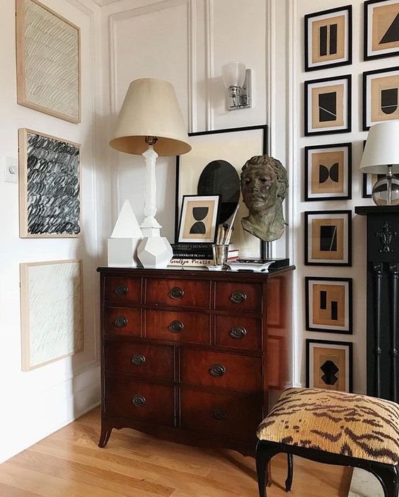 A dark stained credenza with some decor and a gallery wall will add chic to any space