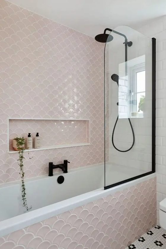 a delicate and cute bathroom done with white subway and blush fishscale tiles, black fixtures for a more modern look