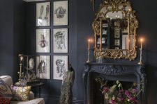 a dramatic Goth living room with soot walls, a refined vintage fireplace, a chic chandelier and a mirror and a gallery wall