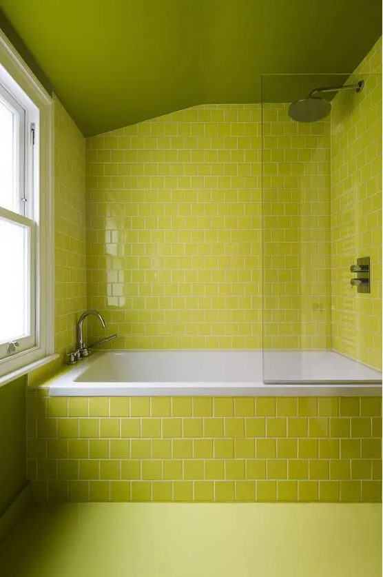 a fully chartreuse bathroom with square tiles and a glass wall is a cool idea if you love bold colors