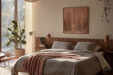 a light-filled earthy bedroom with windows and a glazed wall, a bed with neutral bedding, nightstands with lamps and greenery