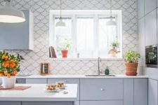 a matte grey kitchen with a white fishscale tile backsplash that is spread on the whole wall
