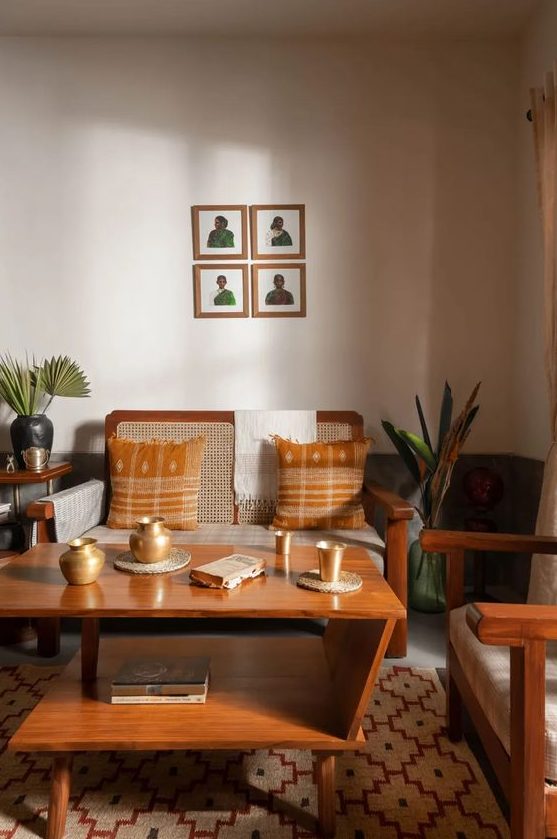 a mid-century modern living room in earthy tones, with a wicker loveseat and chair, a tiered coffee table and some plants