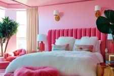 a modern extra bright teen girl room done in pink, with a pink upholstered bed, a pink stool, neutral and pink textiles and potted plants