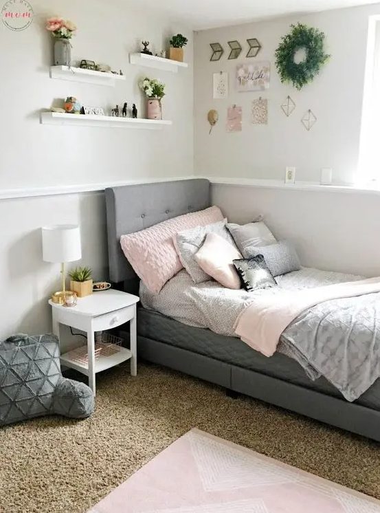 a modern farmhouse teen room with a grey upholstered bed, layered rugs, soft pillows and a gallery wall