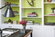 a modern white bookcase gets a new look with chartreuse backing, which makes all the pieces inside stand out a lot