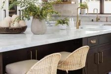 a neutral kitchen with white shaker cabinets, a stone backsplash and open shelves, a dark-stained kitchen island with a stone countertop