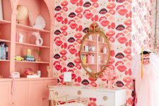 a pretty and bright space with Peach Fuzz bookcases built-in, a kiss accent wall, a white vanity and a glam mirror