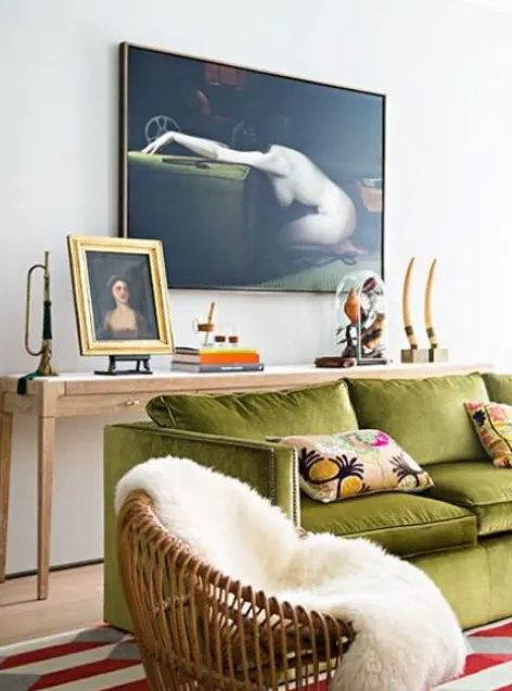 a refined eclectic living room with a long console table, a chartreuse sofa with pillows, a chair and some art