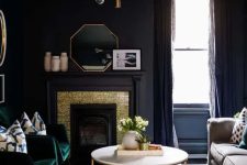 a soot living room with a fireplace clad with gold and soot panels, a neutral sofa, a coffee table, green chairs, a stylish chandelier