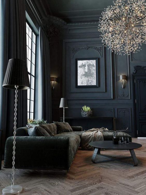 A sophisticated Goth living room with double height ceiling, soot walls, dark furniture, a unique flower inspired chandelier