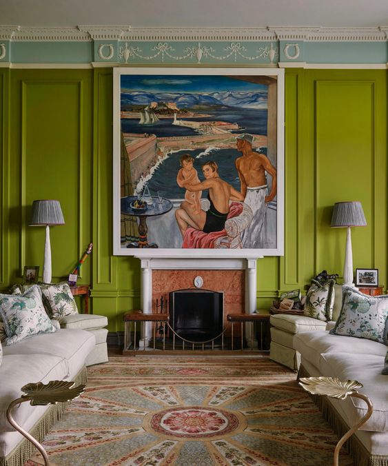 a sophisticated chartreuse living room with molding, a fireplace, white seating furniture and an oversized artwork