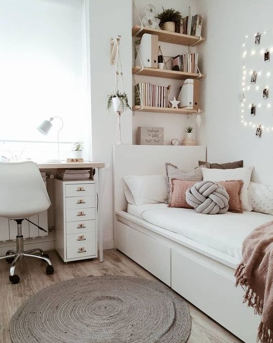 a stylish modern teen girl bedroom in neutrals, with dusty pink touches, lights, a jute rug and potted greenery