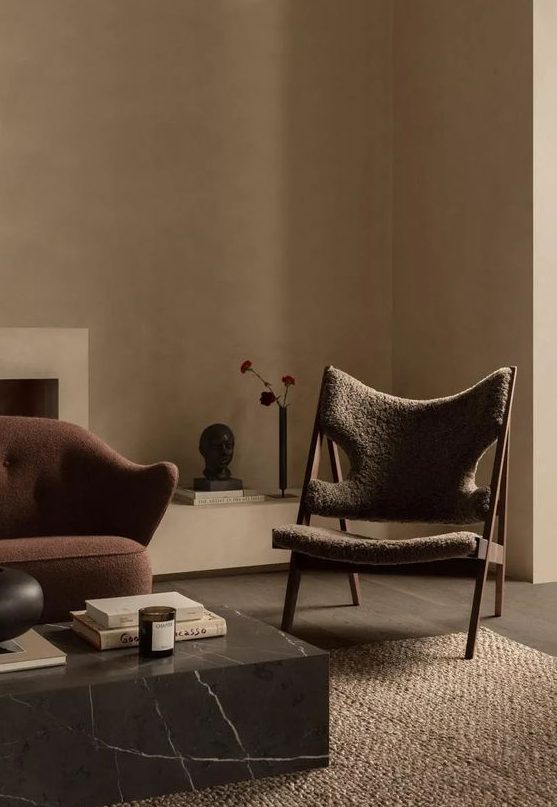 a tan living room with sophisticated furniture of various shades of brown and grey to create a modern earthy look