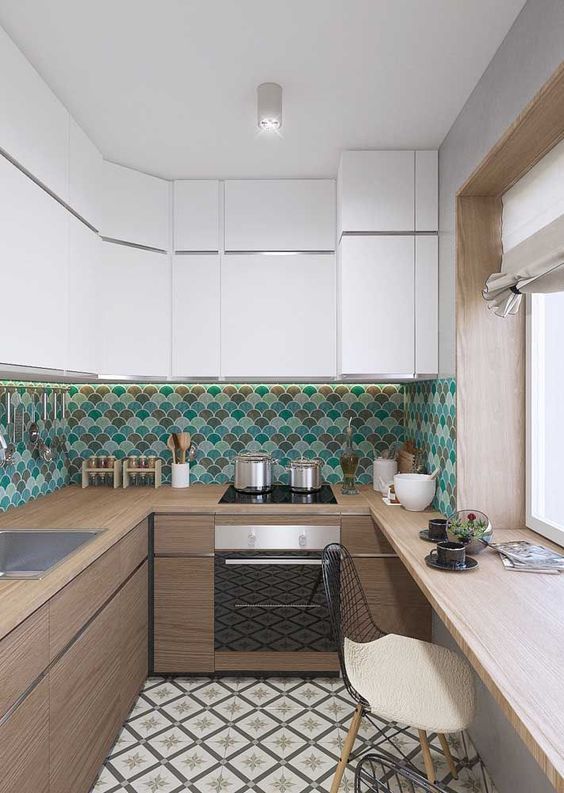 a two-tone kitchen with white and stained cabinets, a bright turquoise, green and brown scallop tile backsplash