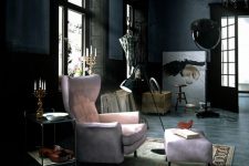 a unique Gothic space with soot walls, an ornated ceiling, a pink chair with a footrest, some wooden furniture, artwork and a rug