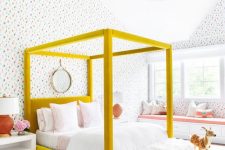 a whimsy modenr teen girl room with bright wallpaper, a mustard canopy bed with neutral bedding, a windowsill bench