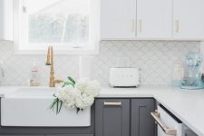 a white and grey kitchen with shaker cabinets, copper fixtures and a scallop tile backsplash is a lovely and chic space